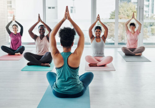 diversity women in yoga class for meditation exercise